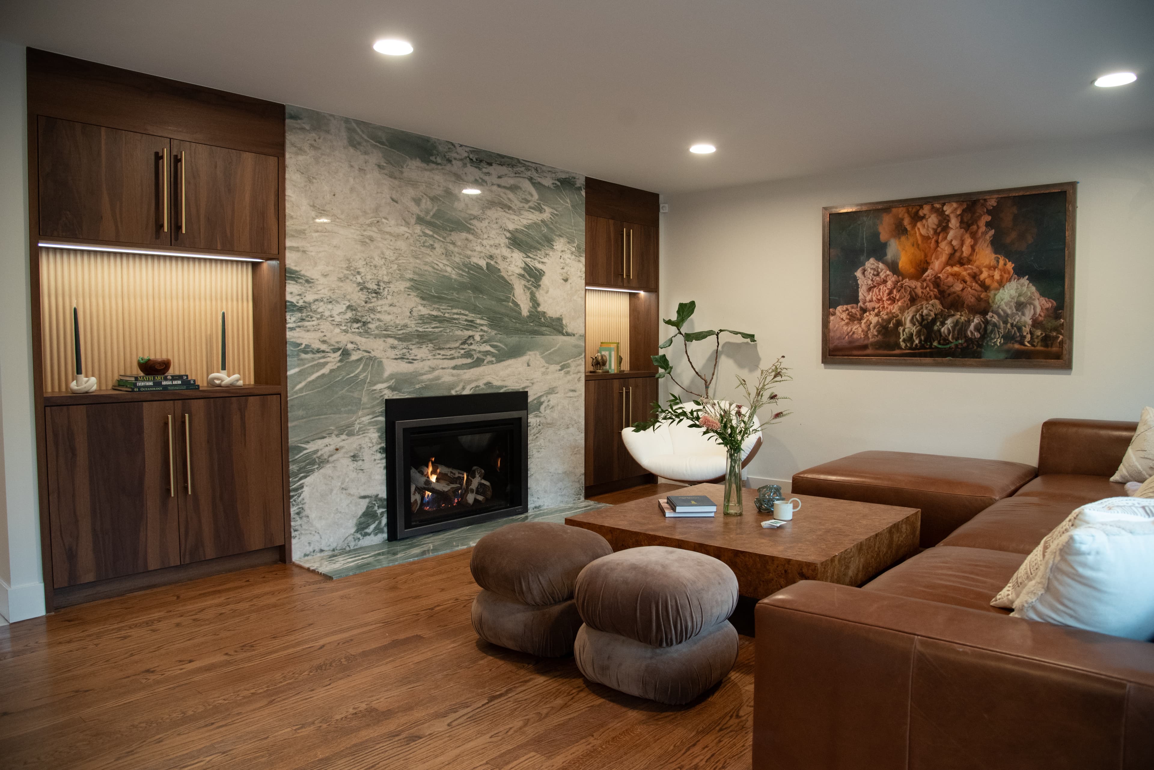 Living room with marble fireplace and custom walnut cabinetry